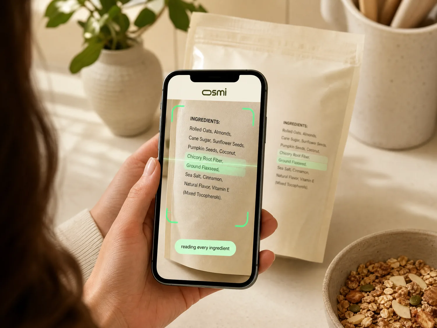 A phone camera pointed at a food package's ingredients label, osmi highlighting ingredients as it reads them.